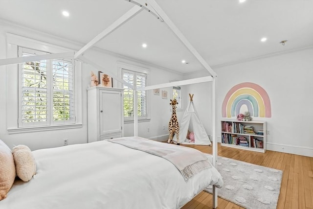 bedroom with wood-type flooring, baseboards, crown molding, and recessed lighting