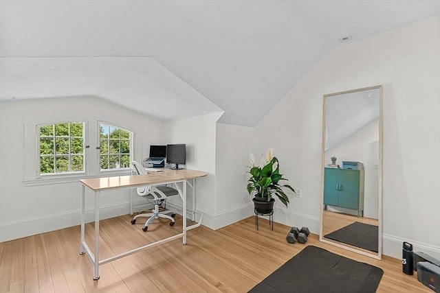 home office with lofted ceiling, wood finished floors, and baseboards