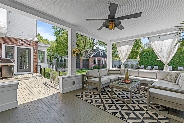 sunroom with an outdoor living space and a ceiling fan
