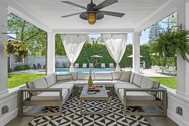 sunroom featuring an outdoor hangout area, healthy amount of natural light, and ceiling fan