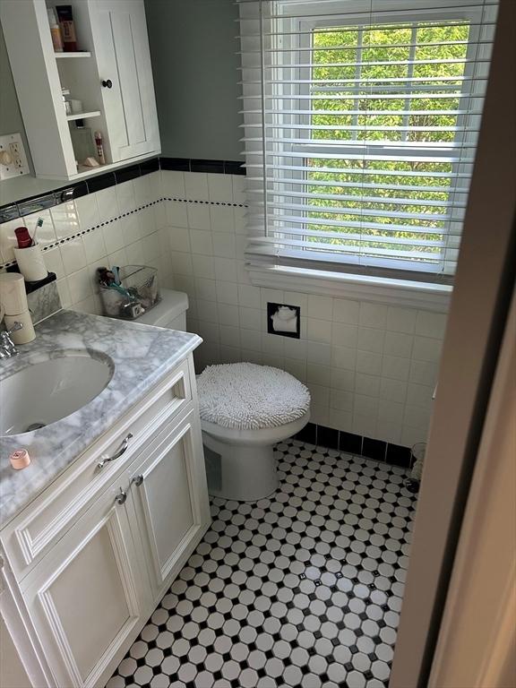 202 Madison St, Dedham, MA 02026 - half bathroom featuring tile walls, toilet, tile patterned flooring, and vanity
