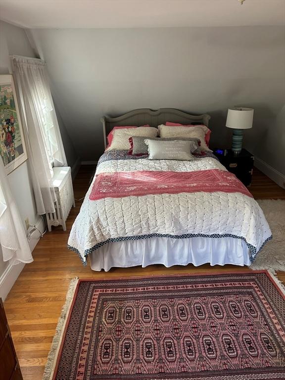 202 Madison St, Dedham, MA 02026 - bedroom featuring radiator heating unit and wood finished floors