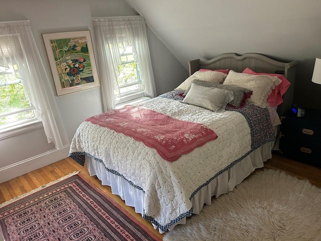 202 Madison St, Dedham, MA 02026 - bedroom with light wood-type flooring, lofted ceiling, and baseboards