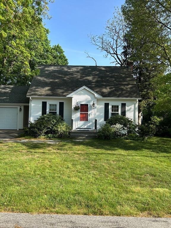 202 Madison St, Dedham, MA 02026 - new england style home featuring an attached garage, a front yard, and roof with shingles