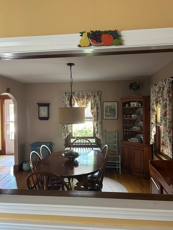 202 Madison St, Dedham, MA 02026 - dining area featuring arched walkways, wood finished floors, and plenty of natural light