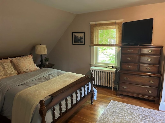 202 Madison St, Dedham, MA 02026 - bedroom featuring radiator, wood finished floors, and vaulted ceiling