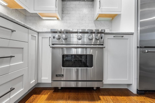 114 Trowbridge St Unit 2, Cambridge, MA 02138 - kitchen view of appliances with stainless steel finishes, white cabinets, backsplash, and light countertops