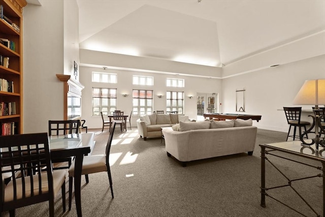 carpeted living room featuring high vaulted ceiling