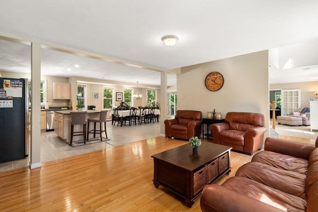 living area featuring light wood-style floors and an inviting chandelier