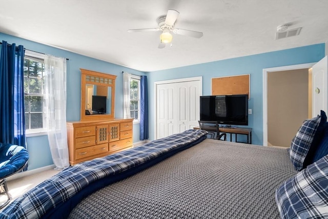 bedroom with carpet, a closet, multiple windows, and visible vents