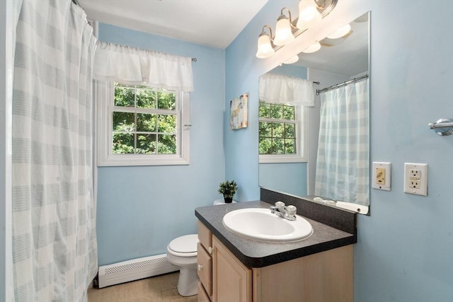 full bath with toilet, a baseboard radiator, a wealth of natural light, and vanity