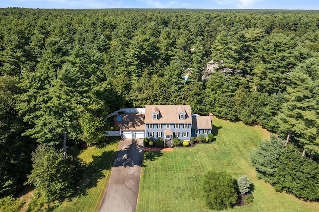 drone / aerial view with a wooded view