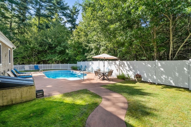 view of pool featuring a yard and a patio