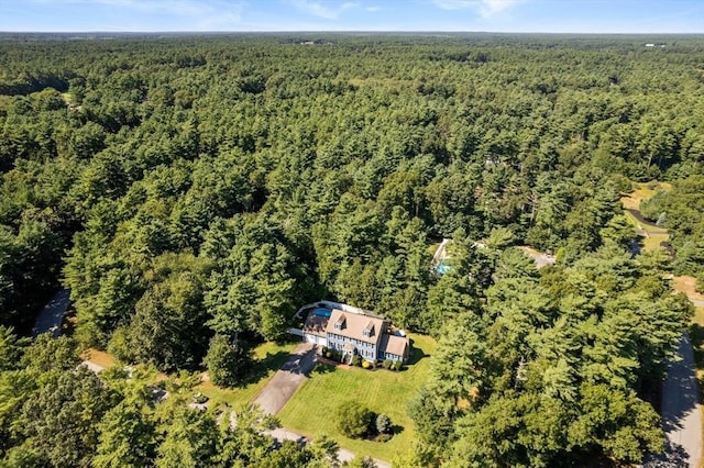 drone / aerial view featuring a wooded view