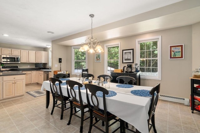 dining room featuring light tile patterned floors, baseboard heating, and a notable chandelier