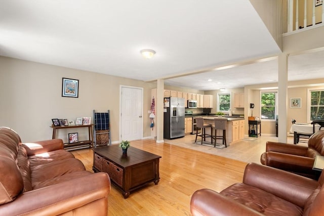 living room with light wood finished floors and baseboards