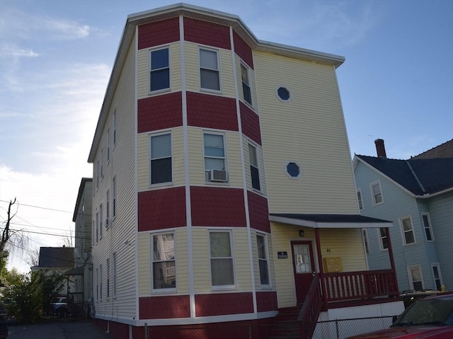 view of front of property featuring a porch and cooling unit