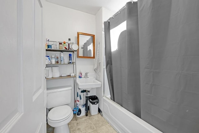full bathroom featuring a sink, tile patterned flooring, toilet, and shower / bath combination with curtain