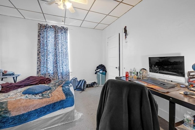 carpeted bedroom with a ceiling fan and a paneled ceiling