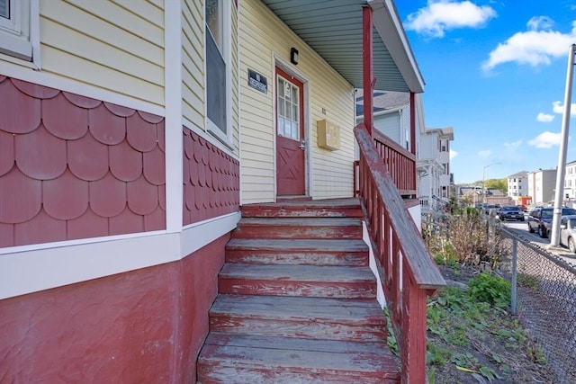 property entrance featuring fence and a residential view
