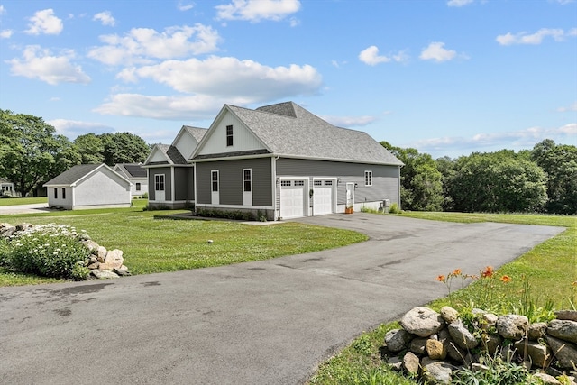 view of front of home with a garage and a front lawn