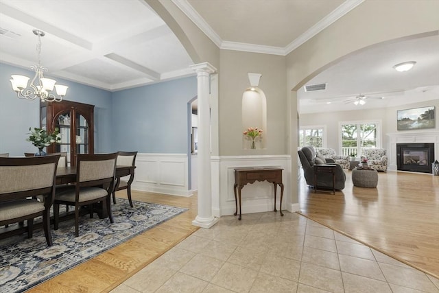 dining area with visible vents, arched walkways, ceiling fan with notable chandelier, and light tile patterned flooring