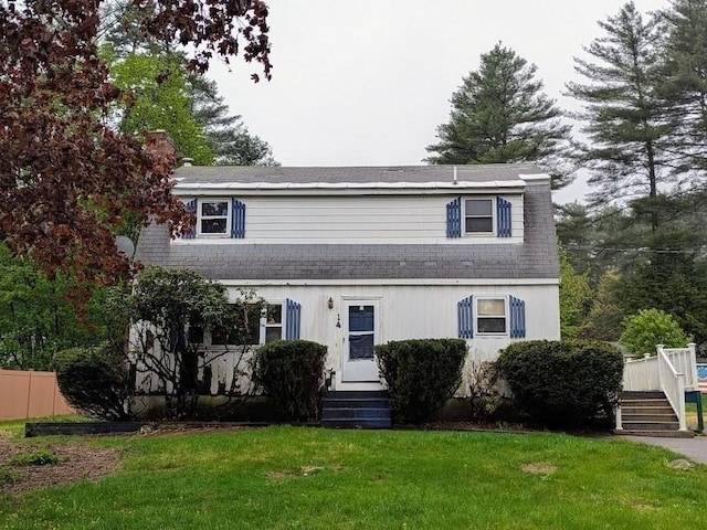 14 Reagan Rd, Townsend, MA 01469 - view of front facade with a front lawn, a wooden deck, and roof with shingles