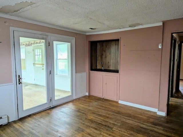 14 Reagan Rd, Townsend, MA 01469 - unfurnished room with a textured ceiling, wood finished floors, crown molding, a wainscoted wall, and a baseboard radiator