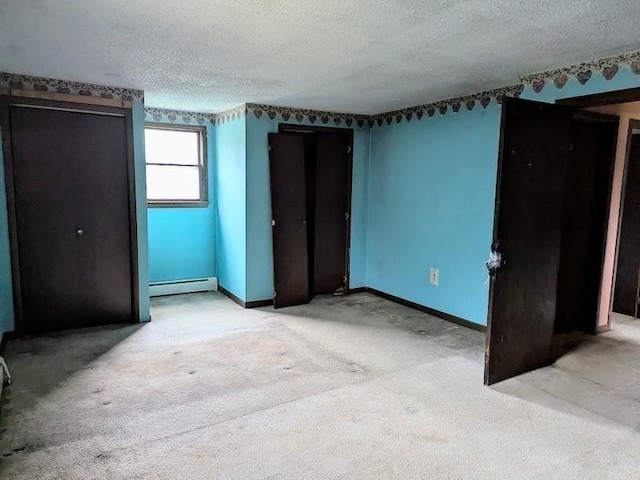 14 Reagan Rd, Townsend, MA 01469 - unfurnished bedroom featuring baseboard heating, light carpet, a textured ceiling, and baseboards