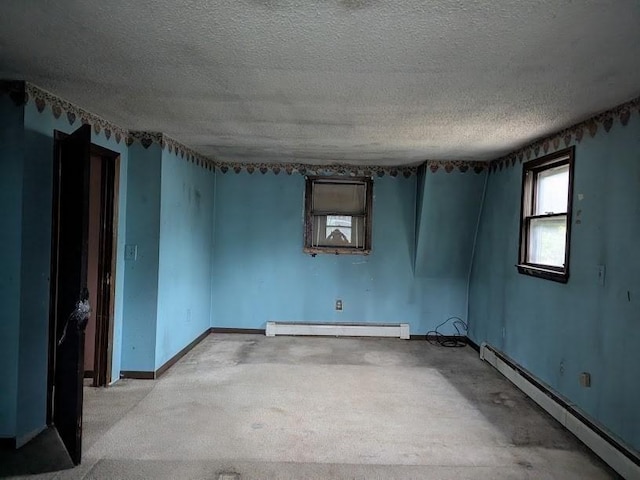 14 Reagan Rd, Townsend, MA 01469 - empty room with baseboard heating, a textured ceiling, and baseboards