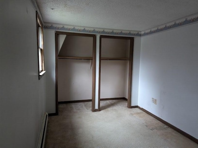 14 Reagan Rd, Townsend, MA 01469 - unfurnished bedroom featuring light carpet, a baseboard heating unit, a textured ceiling, and baseboards