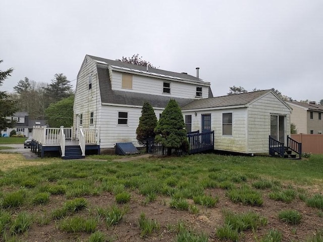 14 Reagan Rd, Townsend, MA 01469 - back of property with a deck, a yard, entry steps, and a gambrel roof