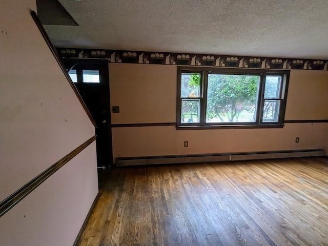14 Reagan Rd, Townsend, MA 01469 - unfurnished room with baseboard heating, a textured ceiling, plenty of natural light, and wood finished floors