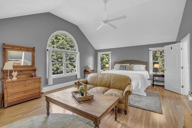 bedroom featuring a baseboard radiator, ceiling fan, lofted ceiling, and light wood finished floors