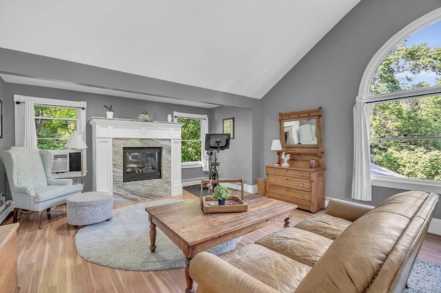 living room with light wood-type flooring, cooling unit, and plenty of natural light