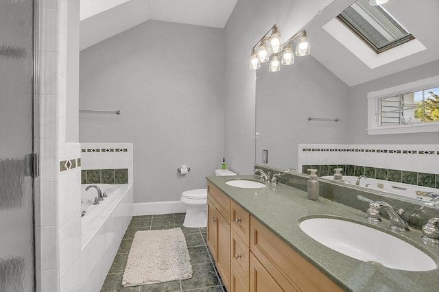 full bath with vaulted ceiling with skylight, a sink, and tile patterned floors