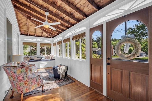 sunroom with a ceiling fan, wood ceiling, and lofted ceiling with beams