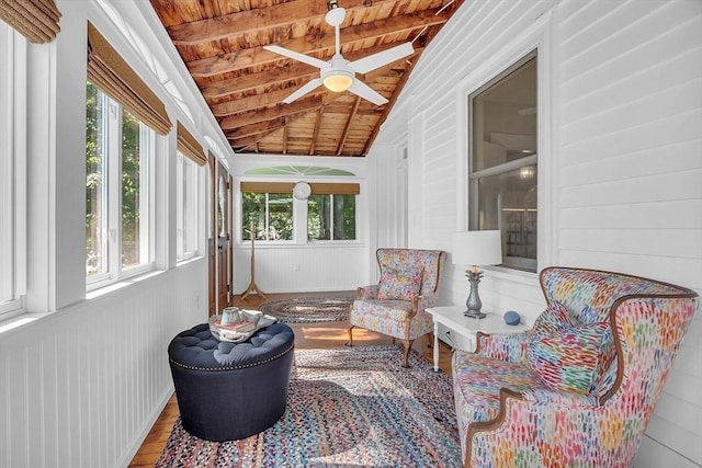 sunroom with vaulted ceiling with beams, wood ceiling, and ceiling fan