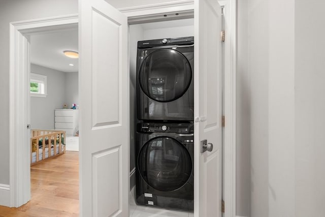 2 Rockwood Ter Unit 2, Newton, MA 02466 - washroom featuring stacked washing machine and dryer and wood finished floors
