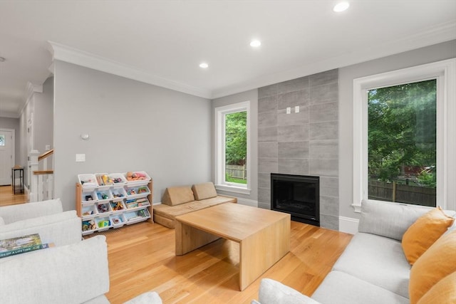 2 Rockwood Ter Unit 2, Newton, MA 02466 - living area with crown molding, healthy amount of natural light, wood finished floors, recessed lighting, and a large fireplace