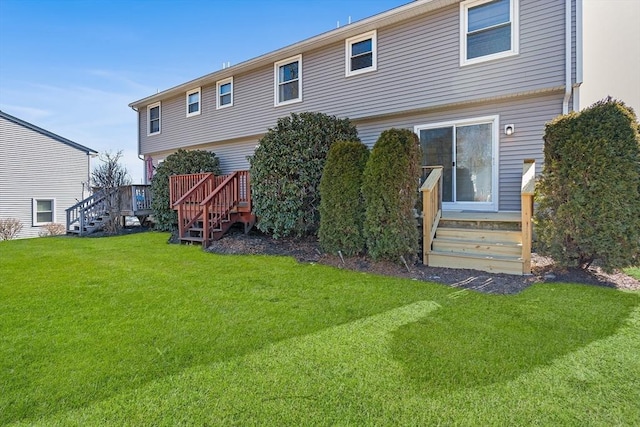 back of house with a lawn and a wooden deck