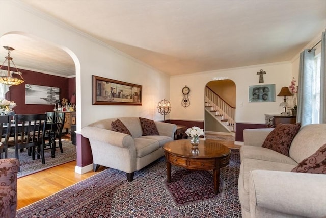 living room featuring hardwood / wood-style floors and crown molding