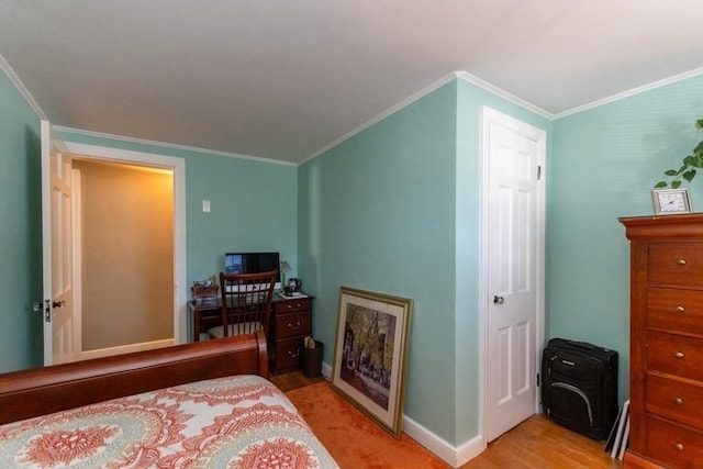 bedroom featuring ornamental molding and light wood-type flooring