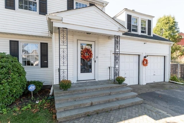 doorway to property with a garage