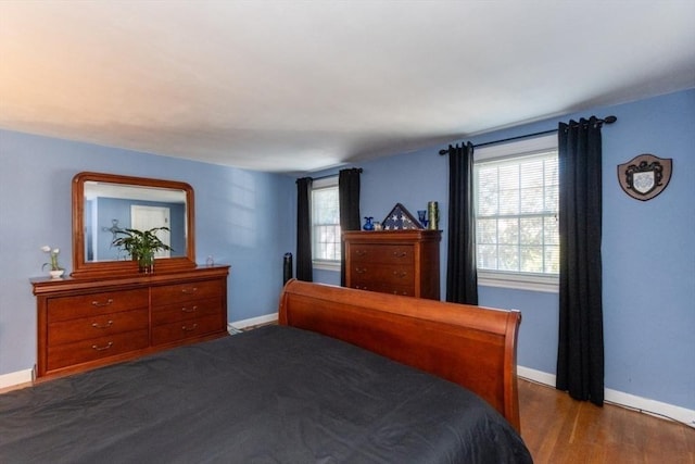 bedroom with dark wood-type flooring