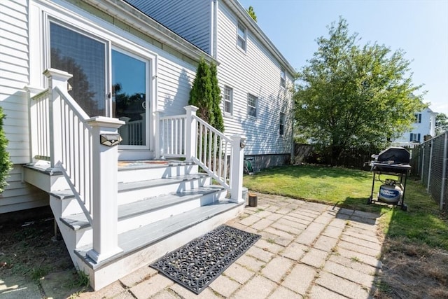 view of side of property featuring a lawn and a patio area