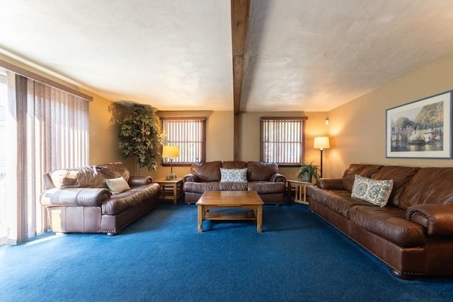 living room with carpet flooring, plenty of natural light, and beamed ceiling