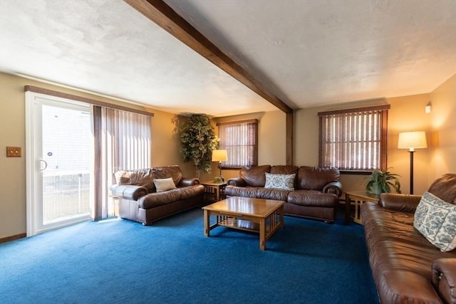 carpeted living room with beam ceiling