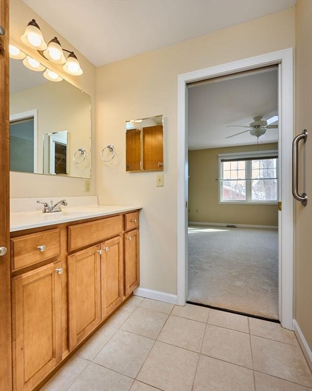 bathroom featuring baseboards, a ceiling fan, and tile patterned flooring