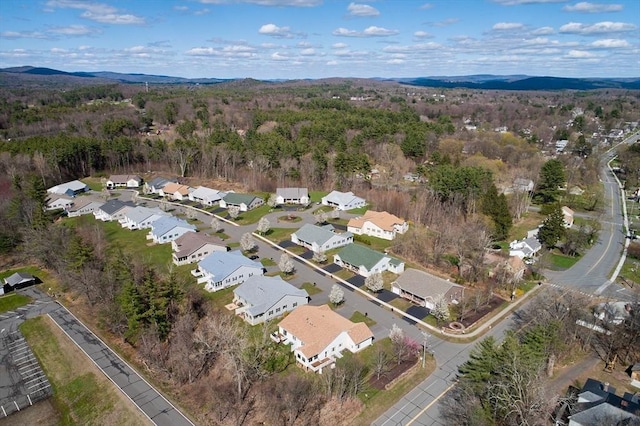 aerial view with a mountain view, a view of trees, and a residential view